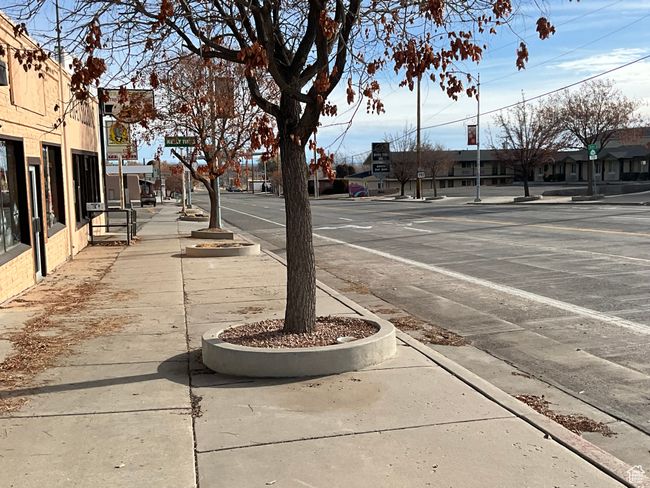 View of street with sidewalks, a residential view, and curbs | Image 7