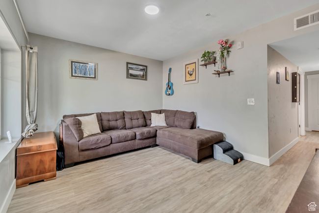 Living area featuring wood finished floors and baseboards | Image 5