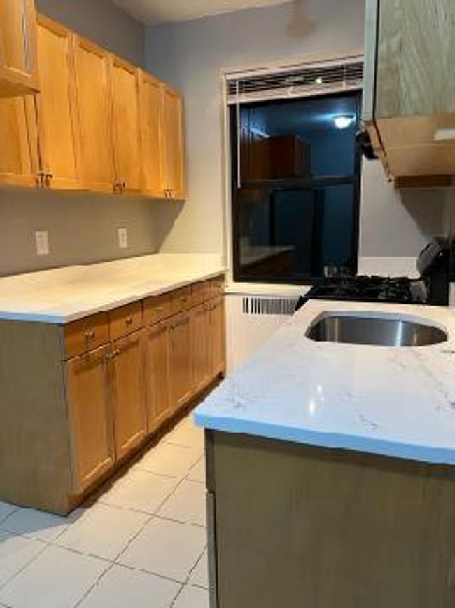 Kitchen with light tile patterned floors and a sink | Image 27