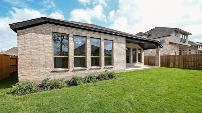 Back of house with a patio area, a fenced backyard, brick siding, and roof with shingles | Image 13