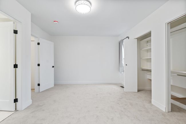 Unfurnished bedroom with baseboards and light colored carpet | Image 14