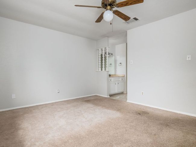 Unfurnished room with a ceiling fan and light colored carpet | Image 14