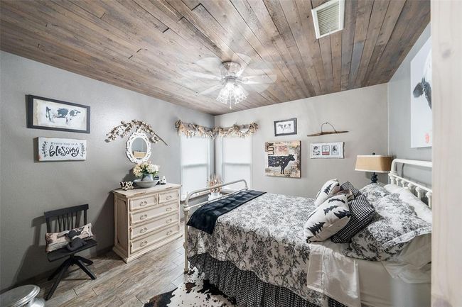 A secondary bedroom featuring generous space and abundant natural light. | Image 36