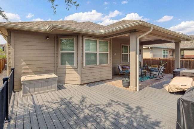 Deck featuring a fenced backyard and a patio area | Image 25