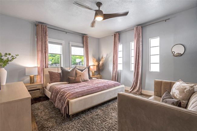 Bedroom featuring wood finished floors, a textured ceiling, baseboards, and a ceiling fan | Image 13