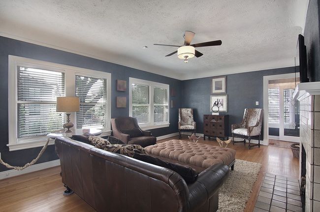 Living room featuring baseboards, light wood-style floors, ceiling fan, and a textured ceiling | Image 24