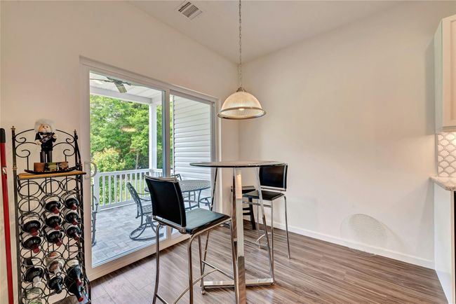 Kitchen area featuring light wood-style floors and baseboards | Image 8
