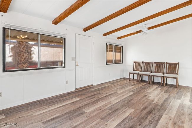 Living room with vaulted ceiling with beams, ceiling fan, and wood style floors | Image 5
