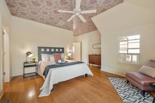 Large windows in the primary bedroom allow natural light to flood the space, creating an airy, open feel that invites you to unwind and enjoy the quiet solitude | Image 20