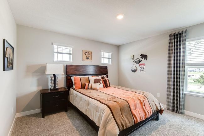 The third bedroom also features a walk-in closet and extra light from multiple windows! Photo of model home, color & options may vary. | Image 21