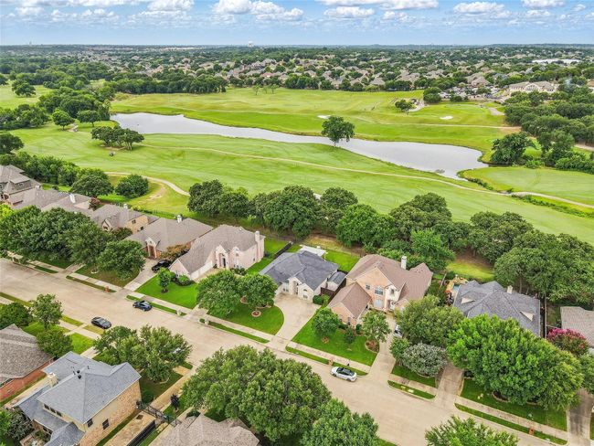 Aerial perspective of suburban area with a large body of water and a golf course | Image 33