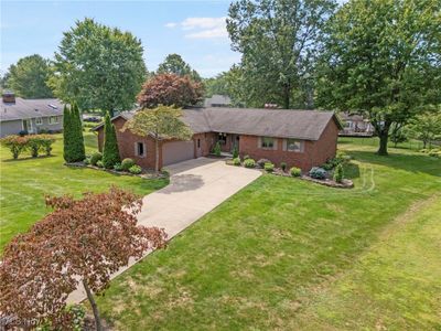 Single story home featuring a garage and a front yard | Image 3