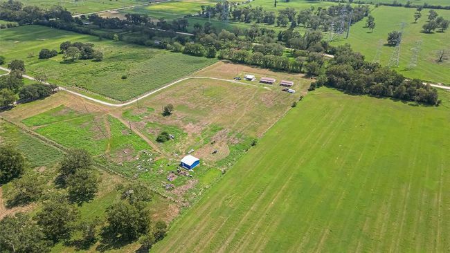This bird’s-eye view reveals the intentional clearing and natural tree groupings, offering a rare balance of accessibility and privacy. | Image 45