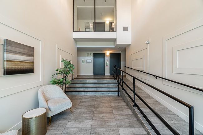 Interior space featuring elevator, a high ceiling, and baseboards | Image 5