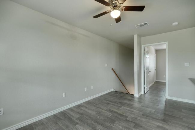 Spare room featuring wood finished floors and ceiling fan | Image 4