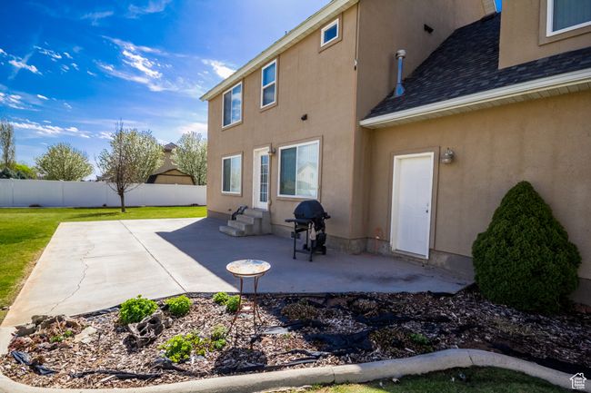 Back of property featuring a patio, fence, entry steps, and stucco siding | Image 33