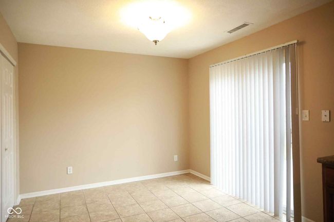 unfurnished room with light tile patterned flooring, visible vents, and baseboards | Image 24
