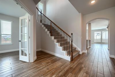 Stairs with ceiling fan, a wealth of natural light, and hardwood / wood-style floors | Image 3