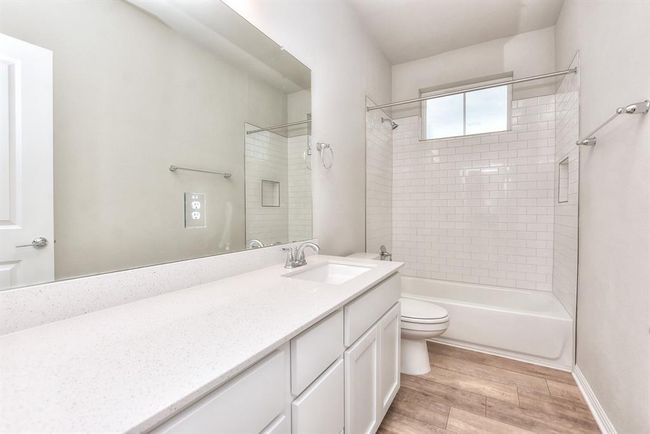 Washroom featuring hookup for a gas dryer, electric dryer hookup, cabinet space, hookup for a washing machine, and light wood-style flooring | Image 21