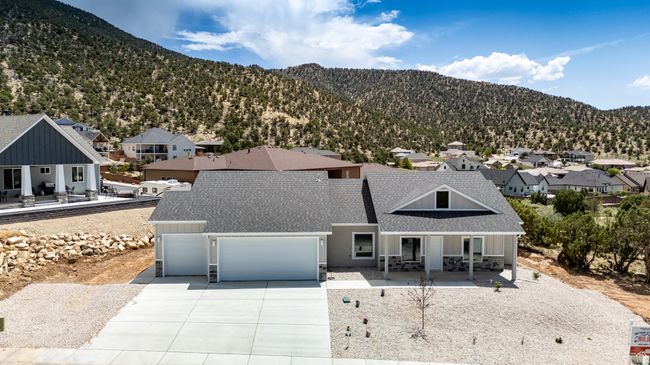 View of front of property featuring a porch, roof with shingles, a residential view, and concrete driveway | Image 53