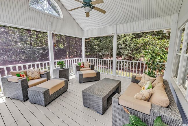 Wooden deck with an outdoor living space and ceiling fan | Image 32