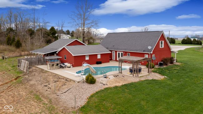 view of pool with a fenced in pool, a water slide, a patio area, fence, and a lawn | Image 44