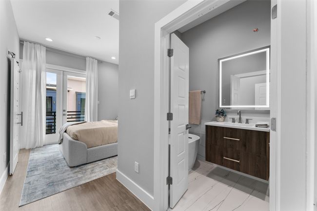 Ensuite bathroom with a freestanding bath, vanity, recessed lighting, baseboards, and visible vents | Image 12