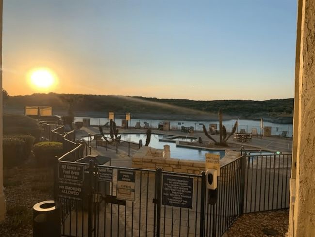 Patio terrace at dusk with a water view and a community pool | Image 17