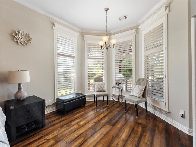 Sitting room featuring a chandelier, wood finished floors, and ornamental molding | Image 21