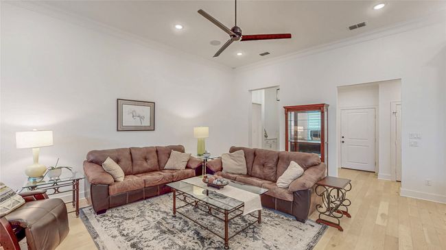 Living area with ornamental molding, ceiling fan, light wood-type flooring, and recessed lighting | Image 9