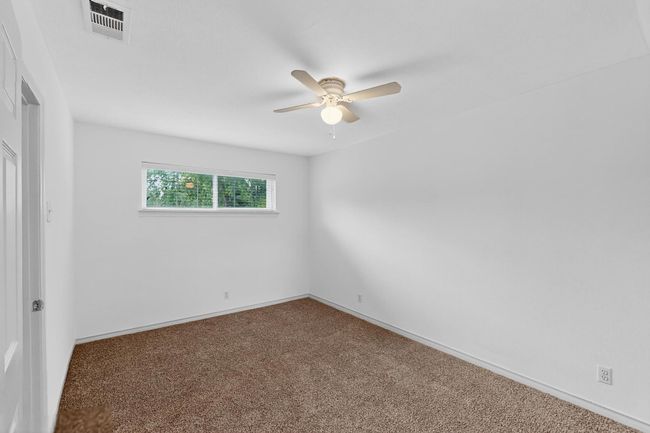 Unfurnished room with a ceiling fan and carpet floors | Image 17