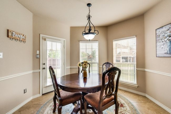 Dining area featuring light tile patterned floors and baseboards | Image 7