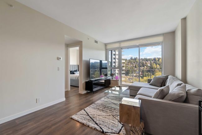 Living area with baseboards, visible vents, and dark wood-style flooring | Image 8