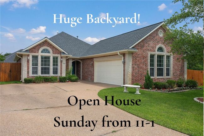 View of front of property with brick siding, concrete driveway, an attached garage, and a shingled roof | Image 27