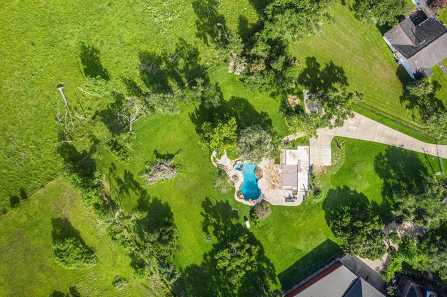 The backyard seamlessly transitions into wide-open pastures at the rear of the property, offering a peaceful, rural setting with ample space and privacy. | Image 5