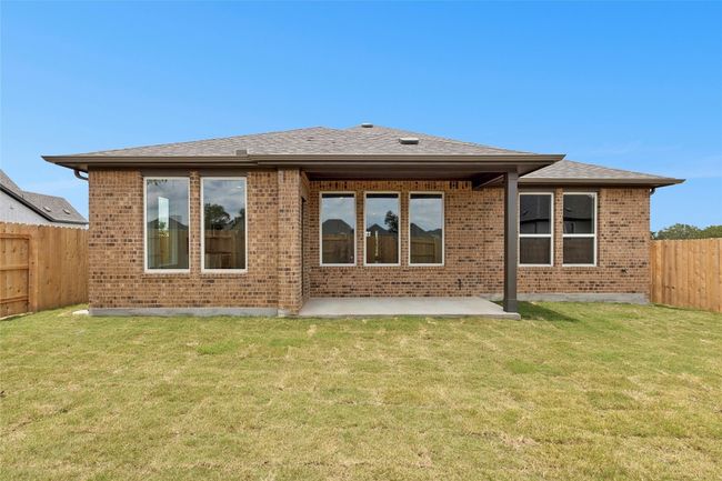 Rear view of house with brick siding, a patio, and roof with shingles | Image 24