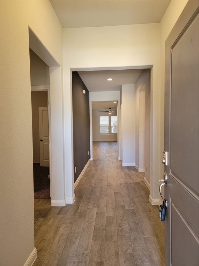 Corridor featuring wood finished floors and baseboards | Image 5