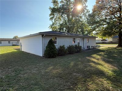 Rear view of house with a yard | Image 3