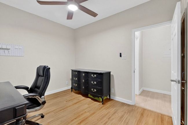 Office space with wood finished floors and a ceiling fan | Image 24