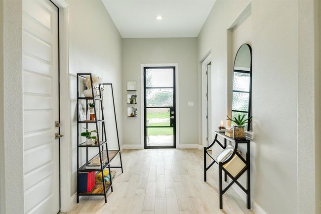 Step into luxury and warmth as youenter this home, where an expansiveand inviting entryway sets the tonefor a grand living experience. | Image 4