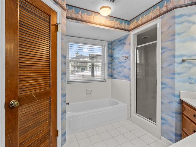 Primary bath with stand up shower and tub. | Image 16