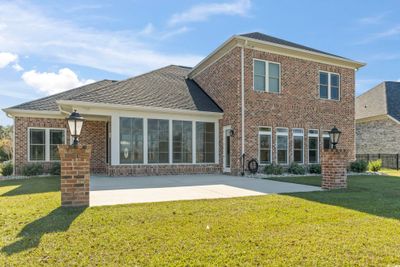 Rear view of property with a waterfront lawn and a patio area | Image 3