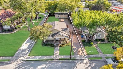 Driveway gate leads to detached garage in rear of lot with plenty of extra parking. | Image 2