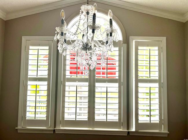 Interior details with ornamental molding, a chandelier, and a textured ceiling | Image 7