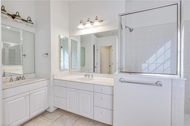 Bathroom with tile patterned flooring, vanity, and walk in shower | Image 36