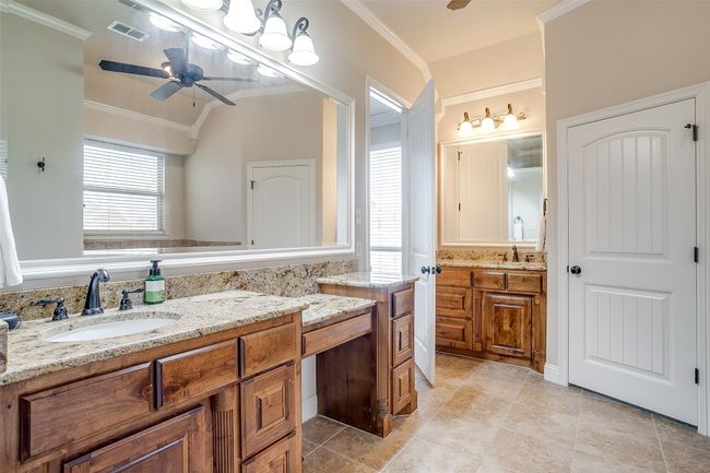Bathroom with a sink, visible vents, ceiling fan, and ornamental molding | Image 17