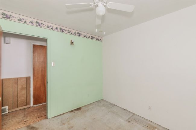 Unfurnished room with a ceiling fan and unfinished concrete flooring | Image 28