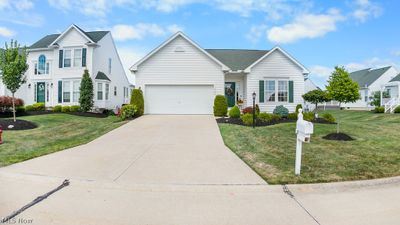 View of front of home with a garage and a front yard | Image 1