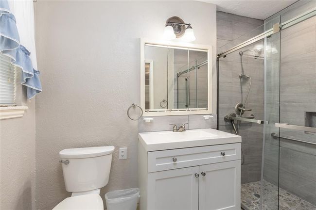 Main Bathroom has been updated with a walk in shower and updated cabinet | Image 17