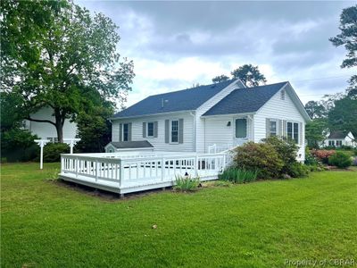 Back of house featuring a deck and a lawn | Image 2